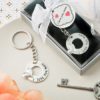 'I love you more' silver metal key chain with embossed heart design