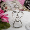 Heart shaped silver metal bottle opener with dangling heart design