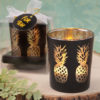 Matte black glass candle holder with shimmering gold pineapples